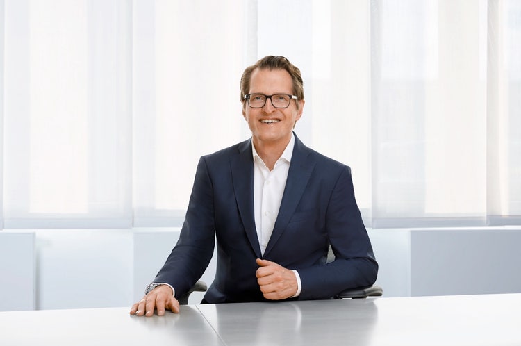Ein Bild, das Kleidung, Menschliches Gesicht, Person, Unternehmer enthält. KI-generierte Inhalte können fehlerhaft sein.